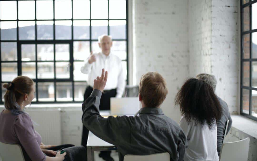 instructor calling on students whose hands are raised