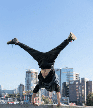 Image of a person doing a handstand in front of a city skyline