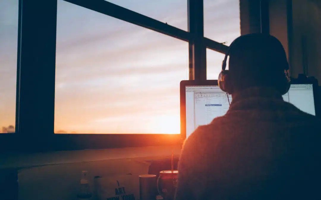 Man at computer with ear set